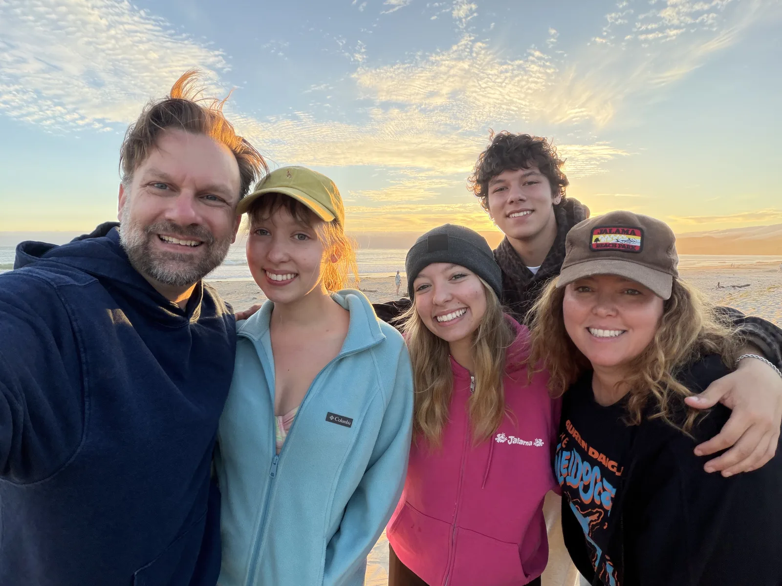 Gwen Swire with her husband and their three children at the beach